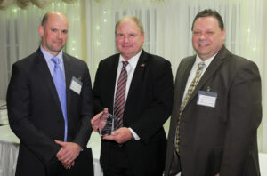 Winner Michael Corrado from Hamilton Township in center with Principal Daniel Cartwright on left and JIF Safety Director John Geitz